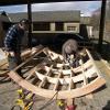 Curved roof panel being fabricated in the workshop