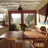 Dining space with roof trusses filtering light