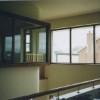 The internal window of the master bedroom looks into the double height space and south to the views beyond